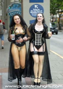 2 Dominas In Seattle - 2 dominas walk around downtown streets on a busy day, dressed in transparent latex, corsets and high heels. Lots and lots of crowd reactions and public fetish at its most extreme.